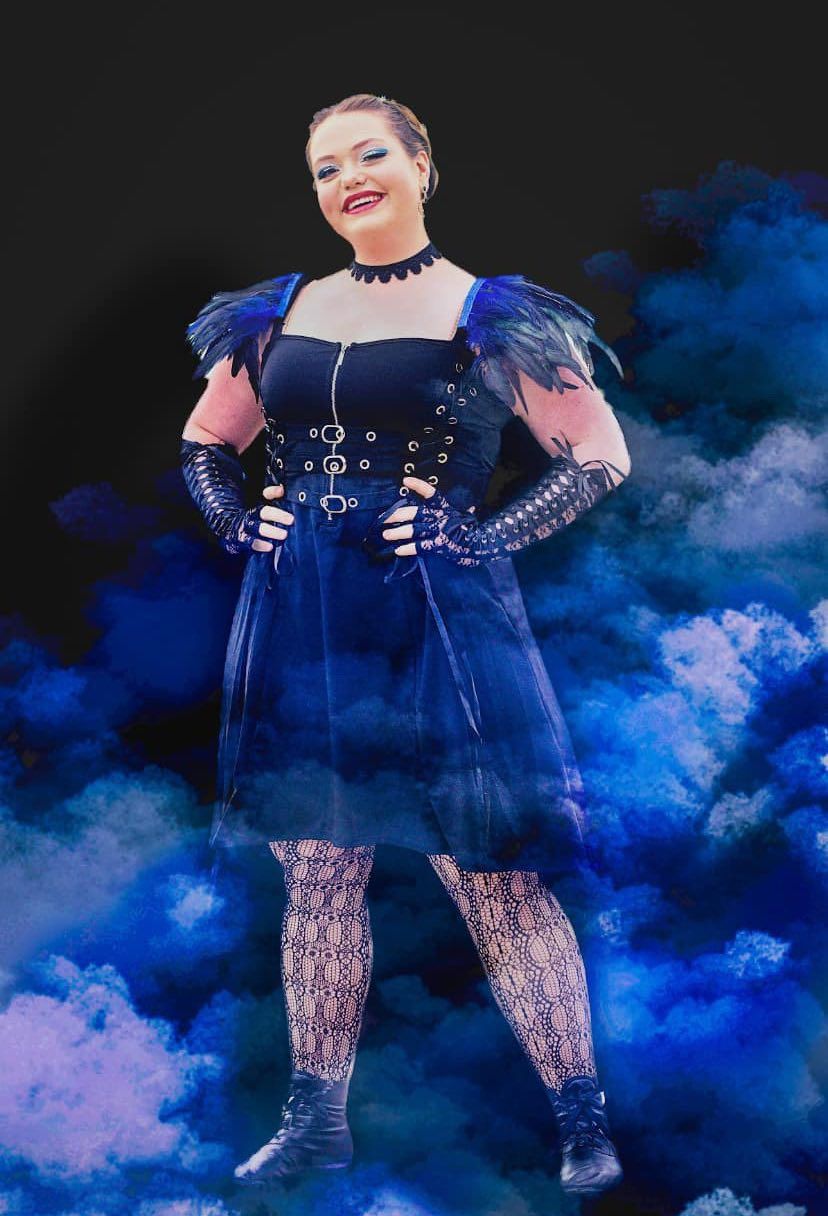 Gothic-inspired dance performance featuring navy costume and blue atmospheric smoke effects.