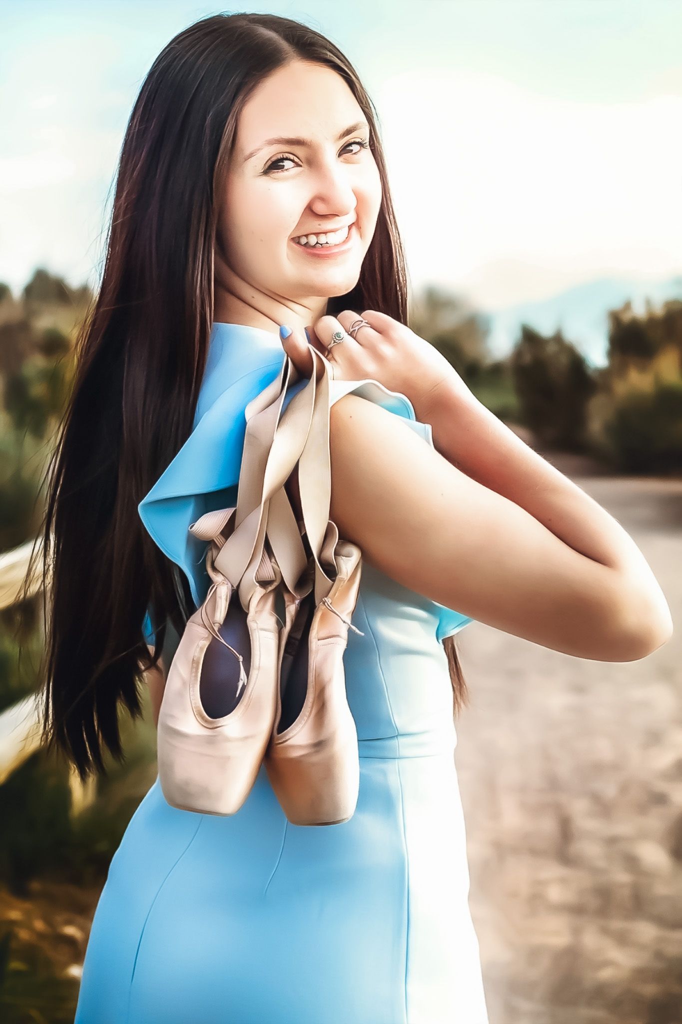 Dance-themed portrait series with ballet pointe shoes against an outdoor setting.