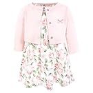 Pink floral baby clothing collection featuring dresses and accessories laid out in a row.