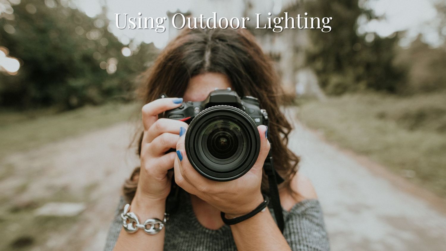 Photographer with professional camera taking outdoor portraits in natural lighting.