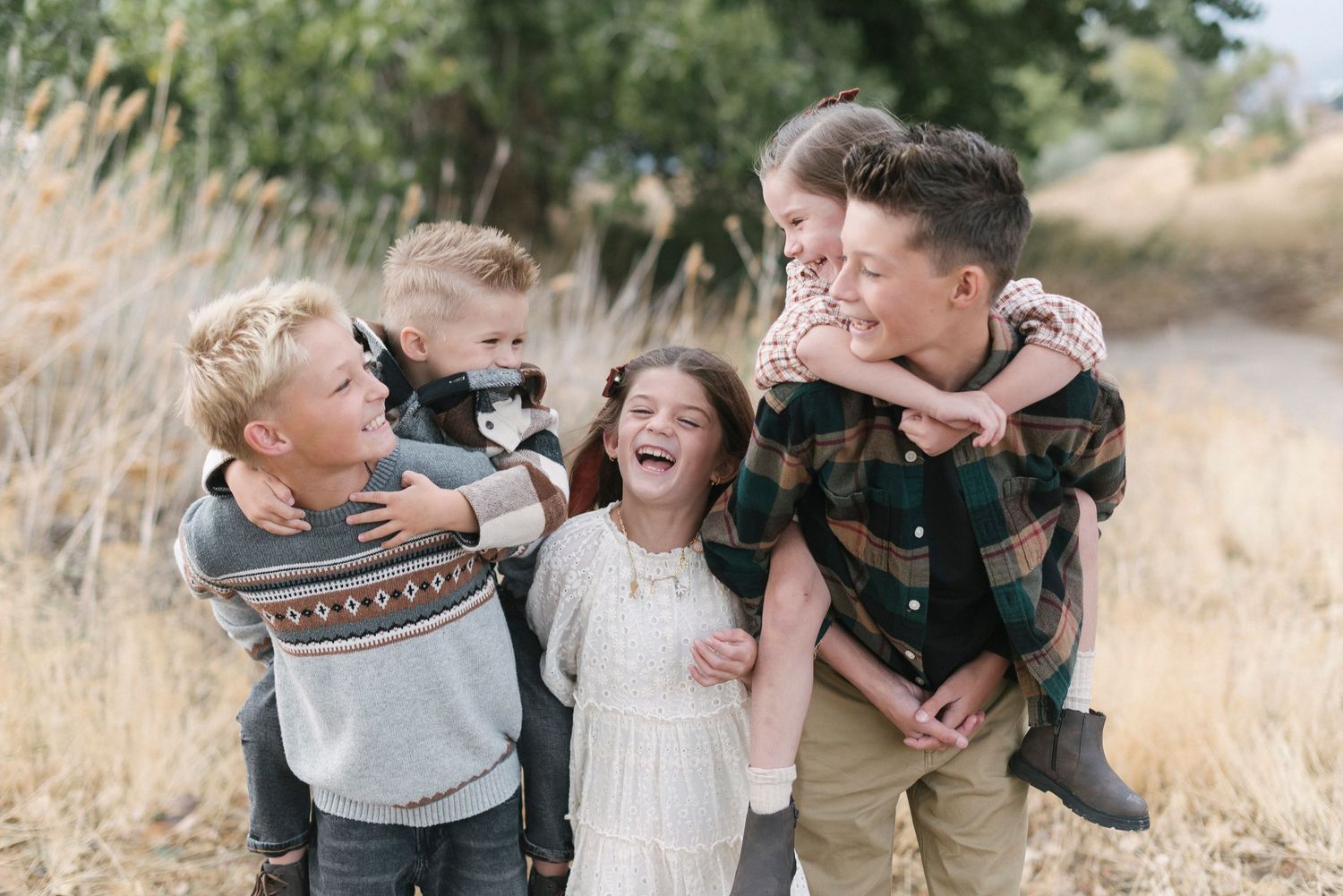 Family playing and laughing together outdoors in a candid moment.