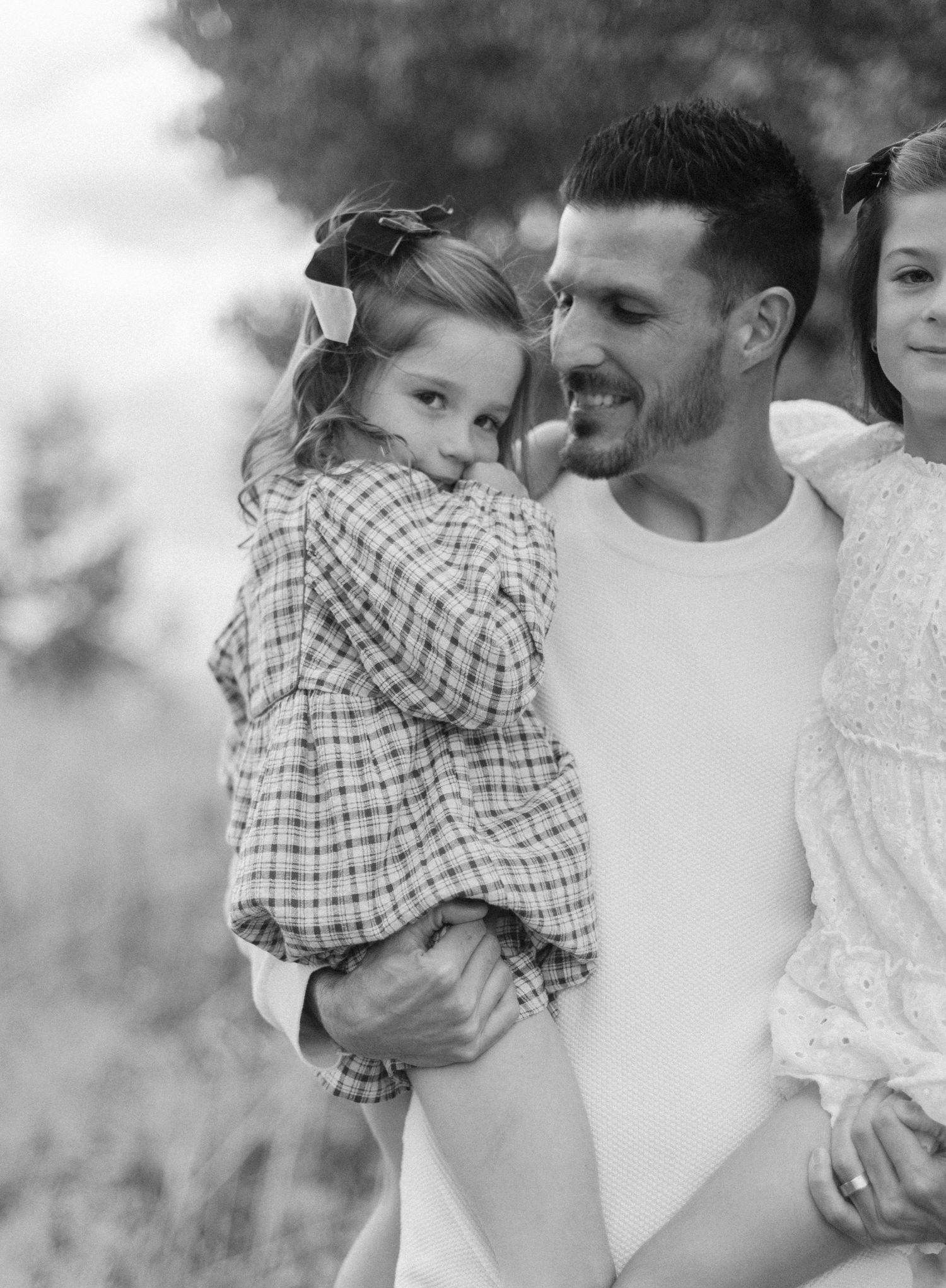 Black and white series of intimate family moments showing affection and laughter.