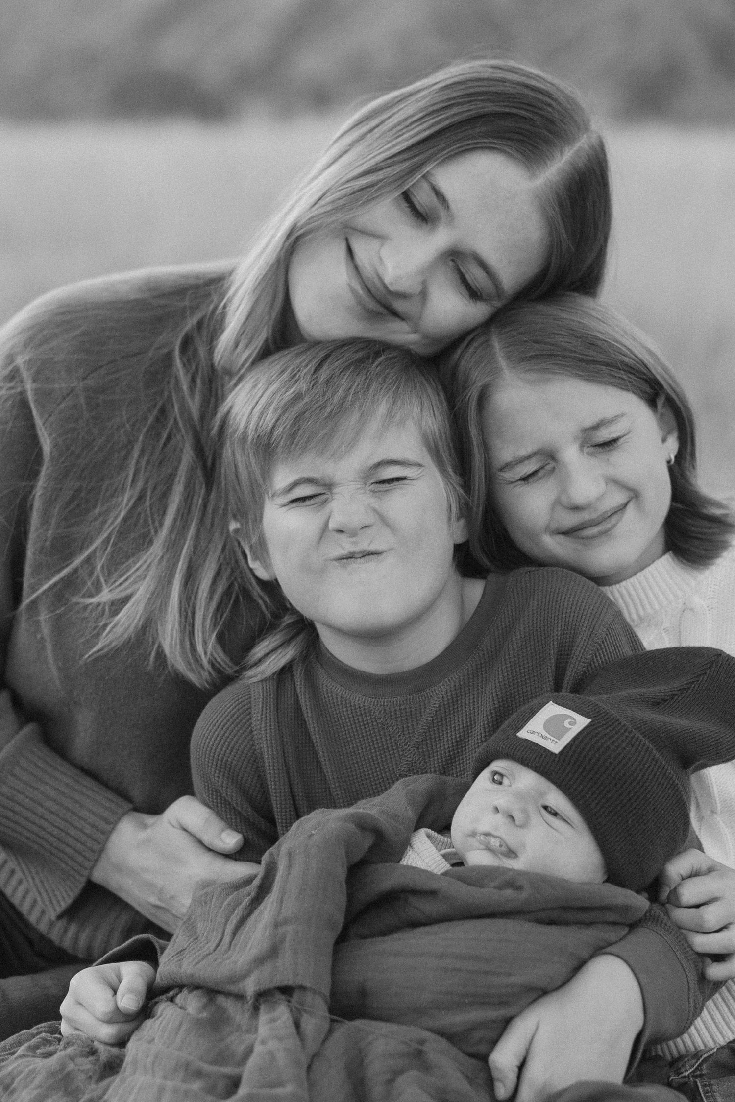 Black and white series showing tender moments of affection and closeness outdoors.