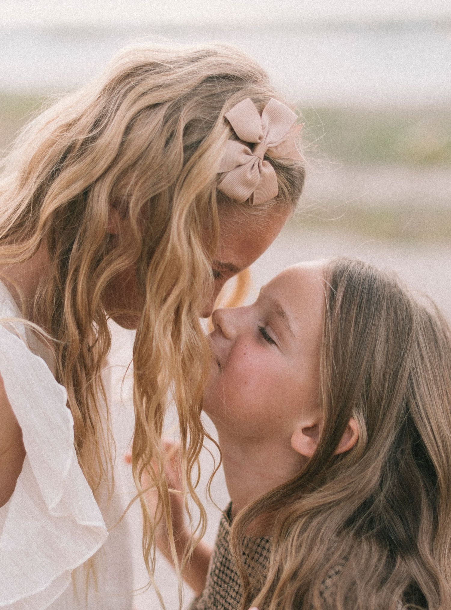 An intimate moment captured between two people with soft natural lighting.