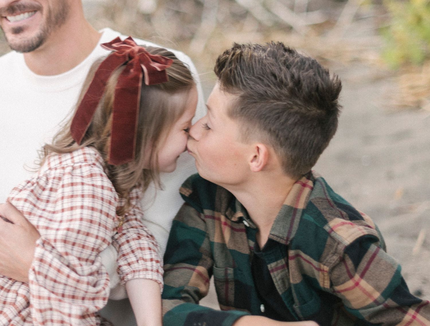 Series of candid family moments showing affection and laughter in outdoor setting.