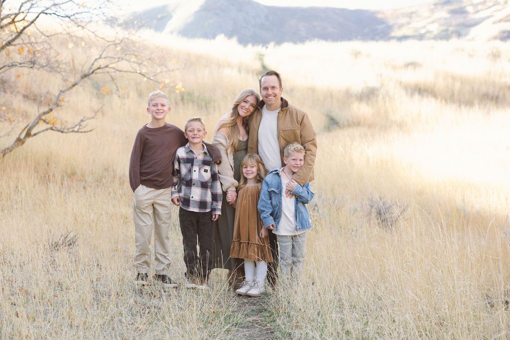A panoramic family portrait series taken in a golden field during sunset.