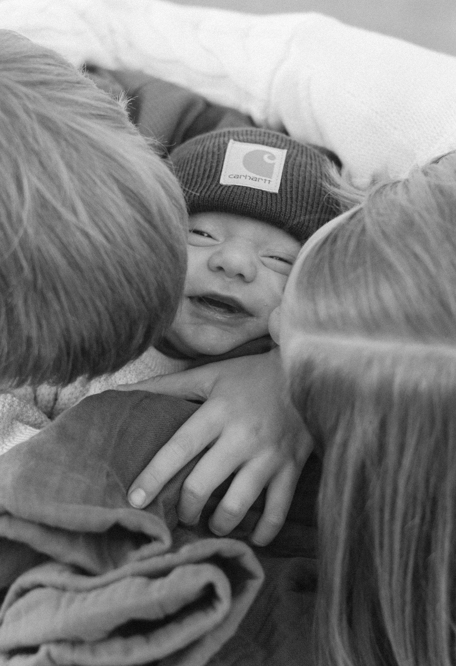Intimate black and white close-up shots showing gentle embraces and connection.