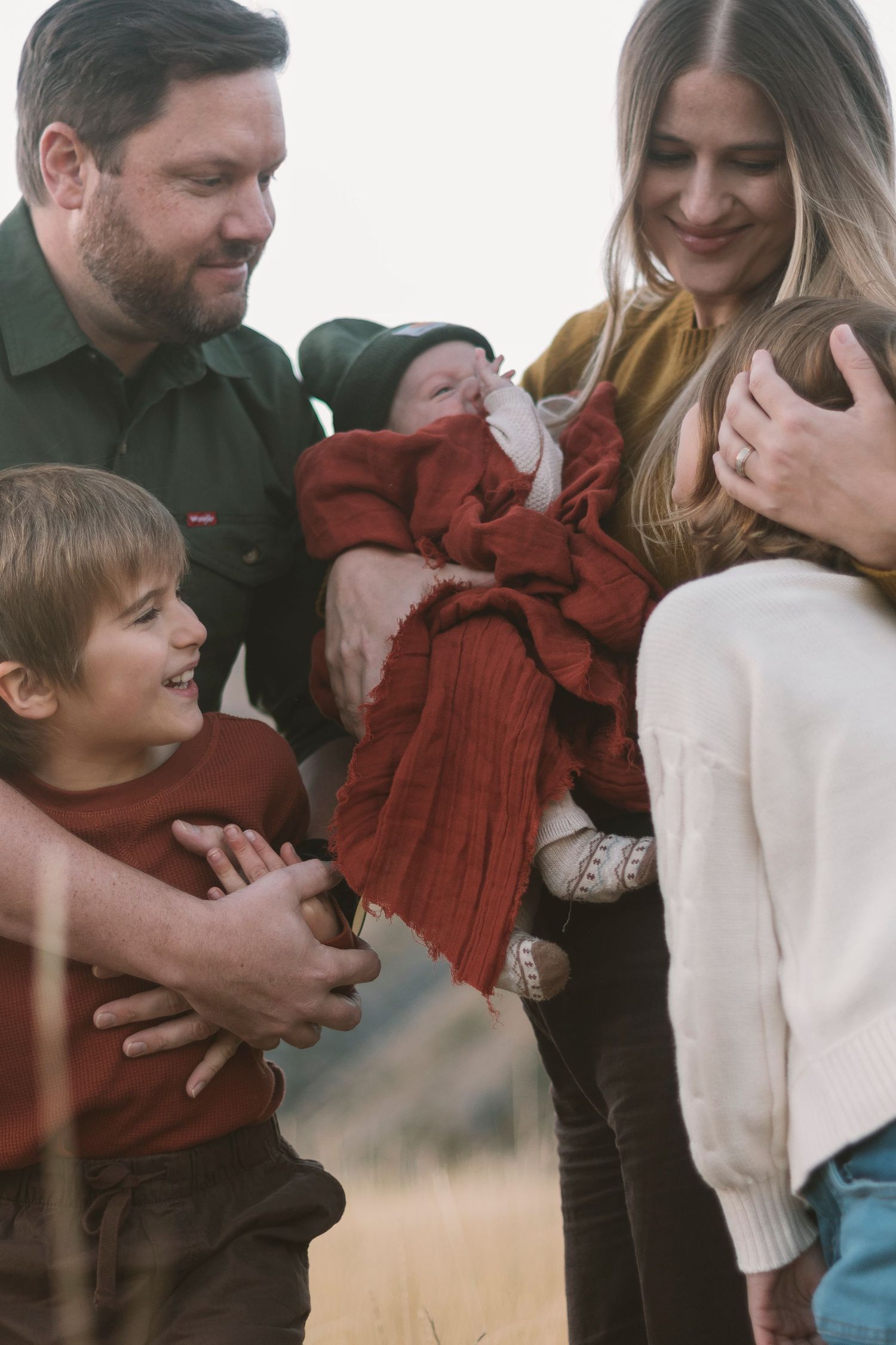 Candid sequence showing family moments of joy and laughter in casual winter clothing.