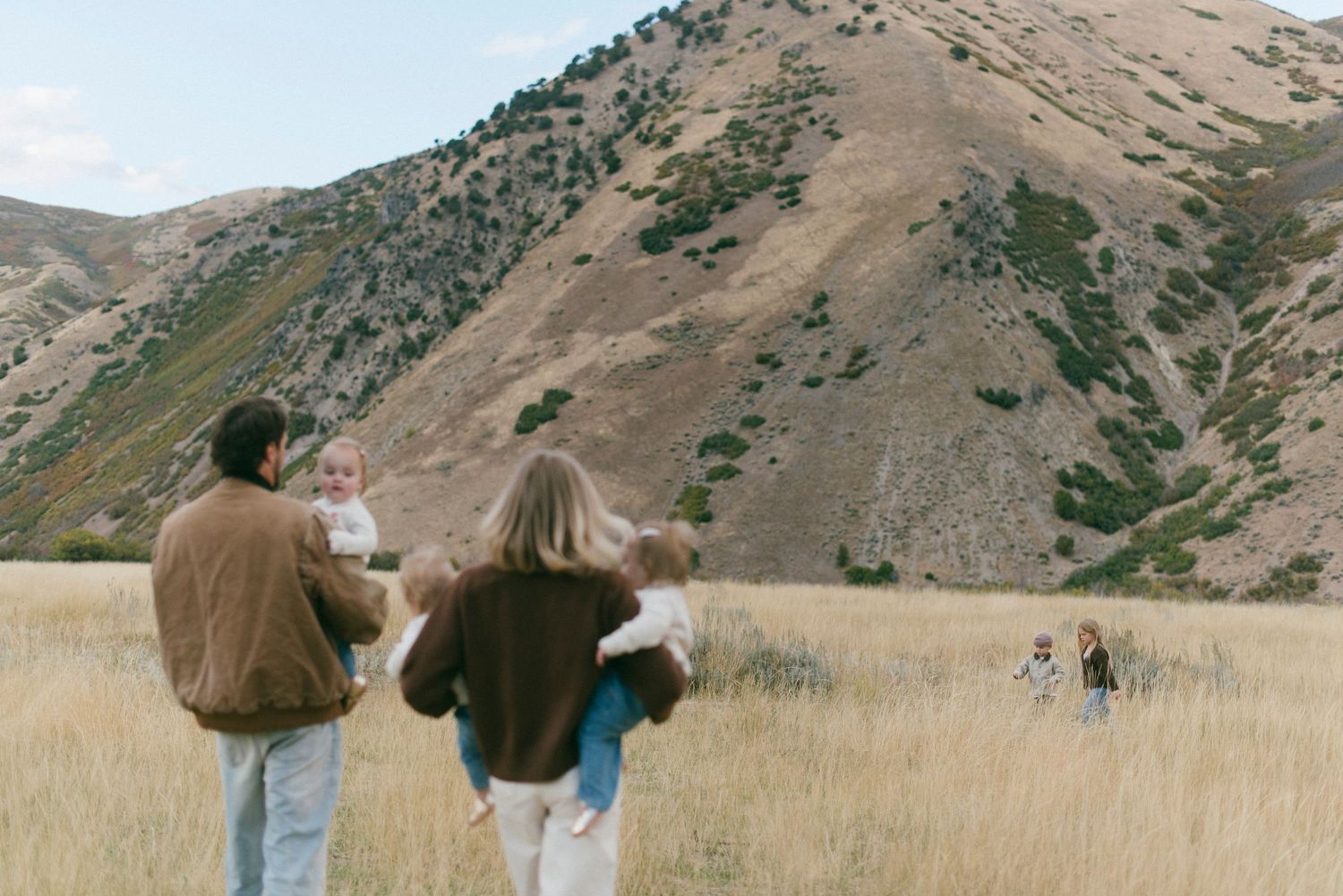 Series of distant shots showing people enjoying time together in a mountainous landscape.