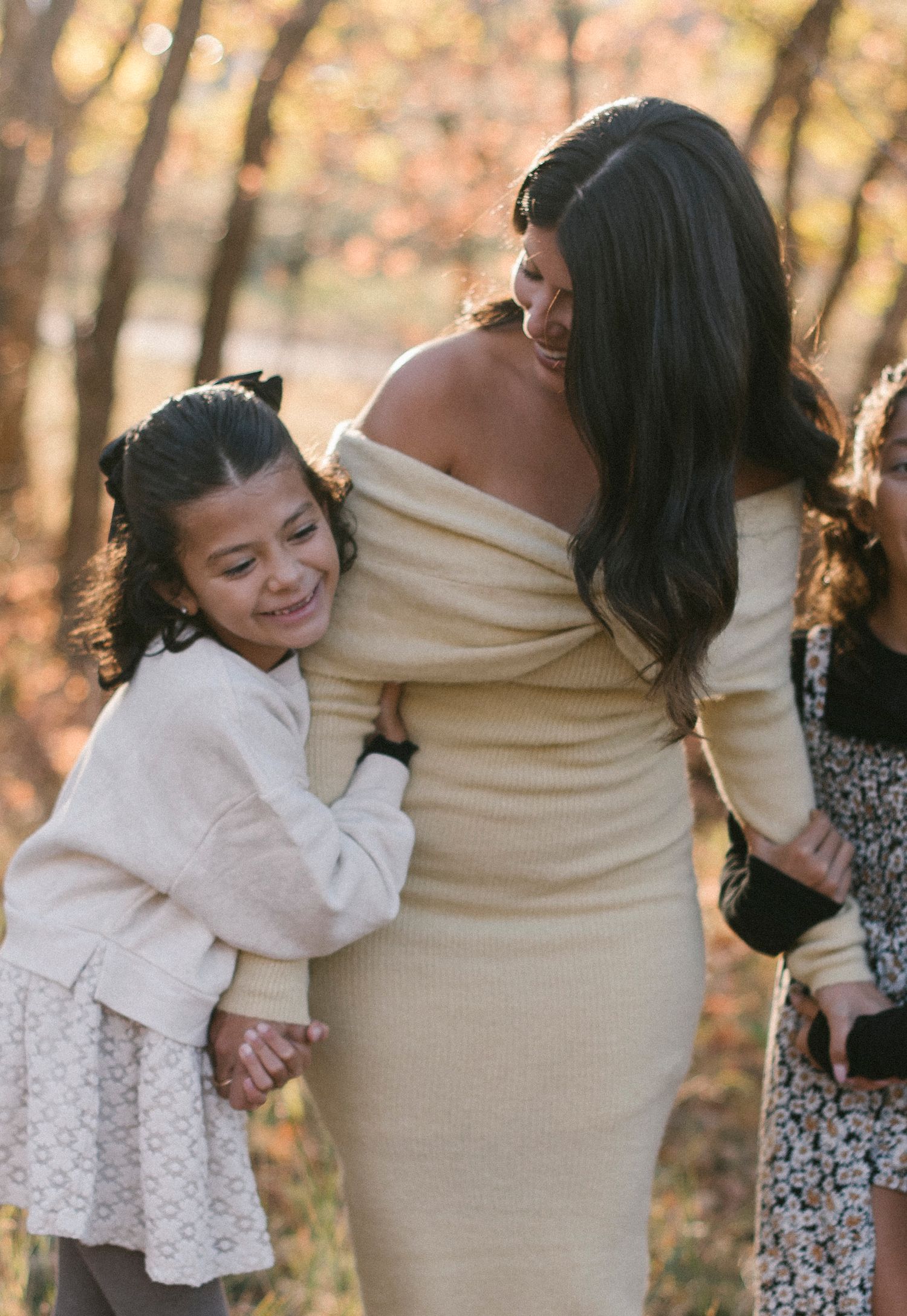 A tender embrace captured during an outdoor family photoshoot in autumn.