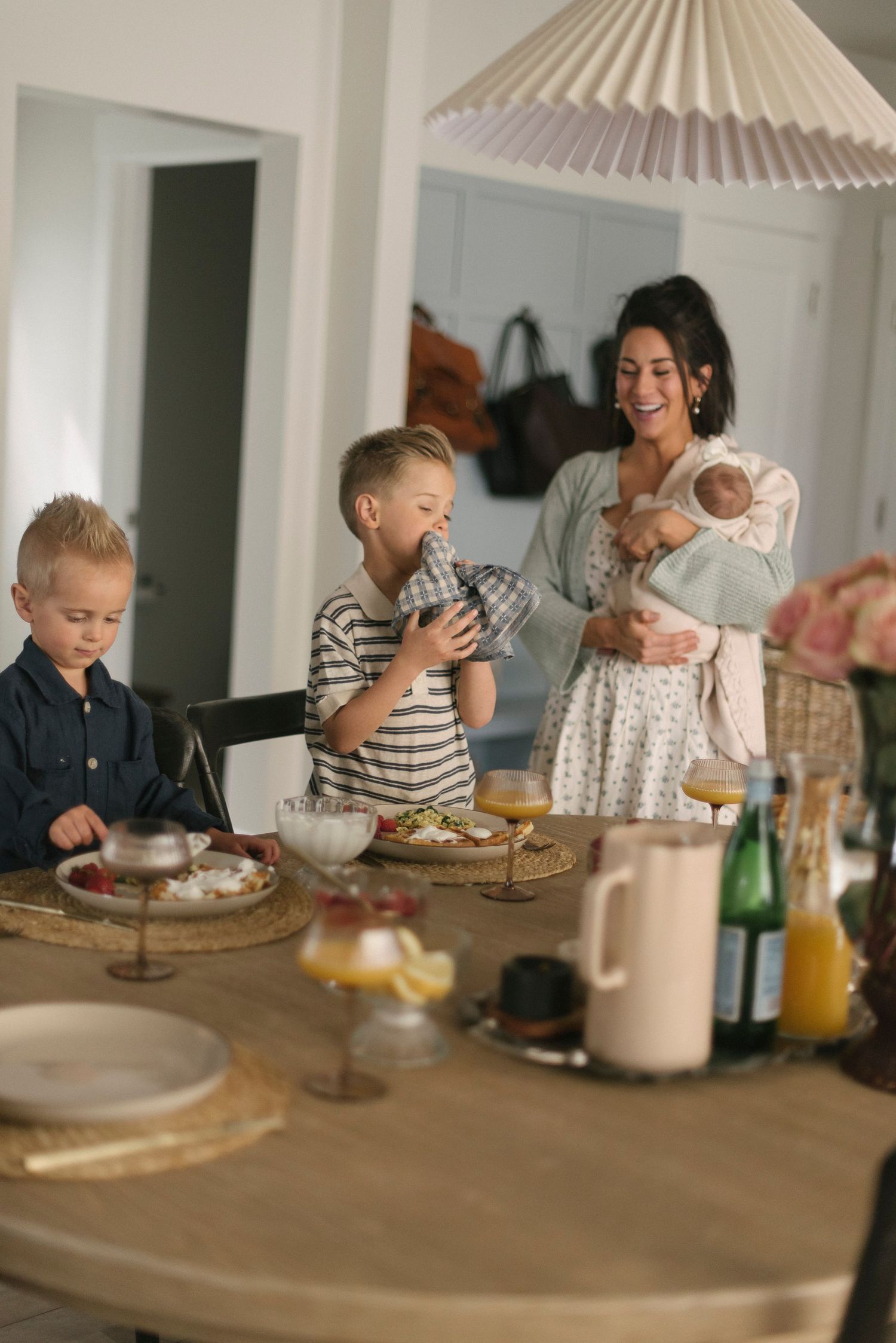 A casual breakfast scene at a wooden table with drinks and snacks.