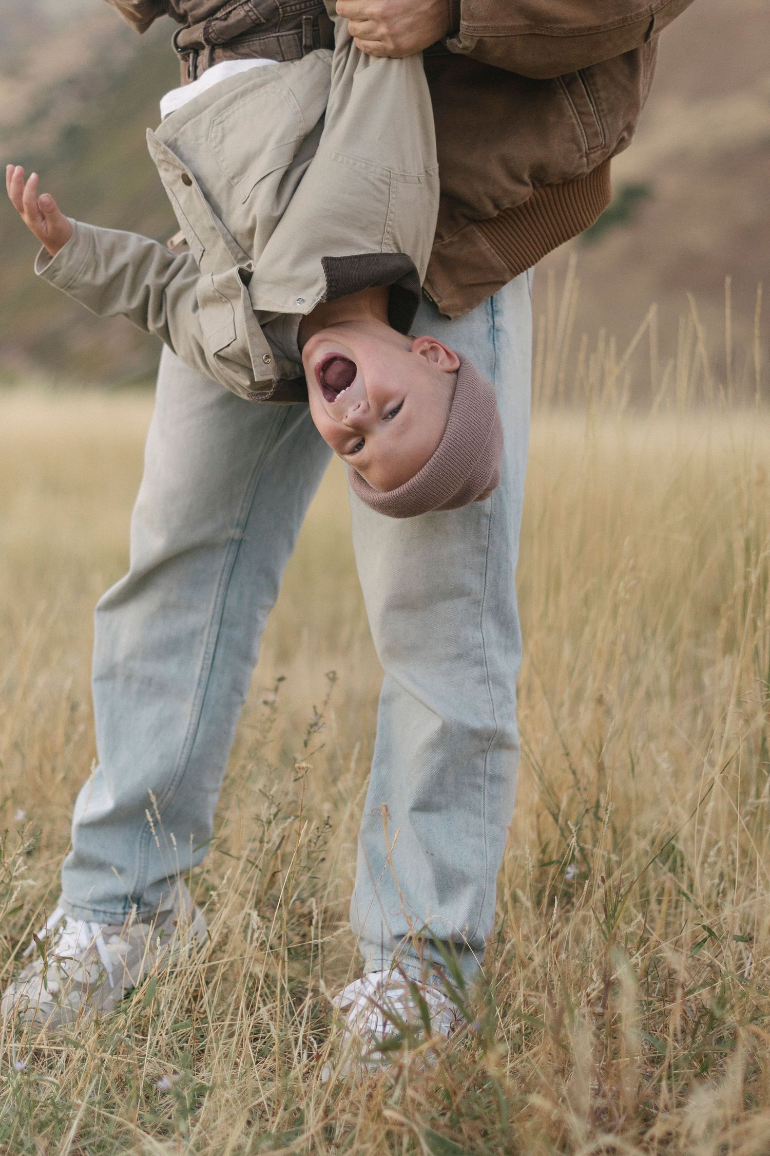 Sequence of photos showing playful interactions in a grassy field wearing casual denim.