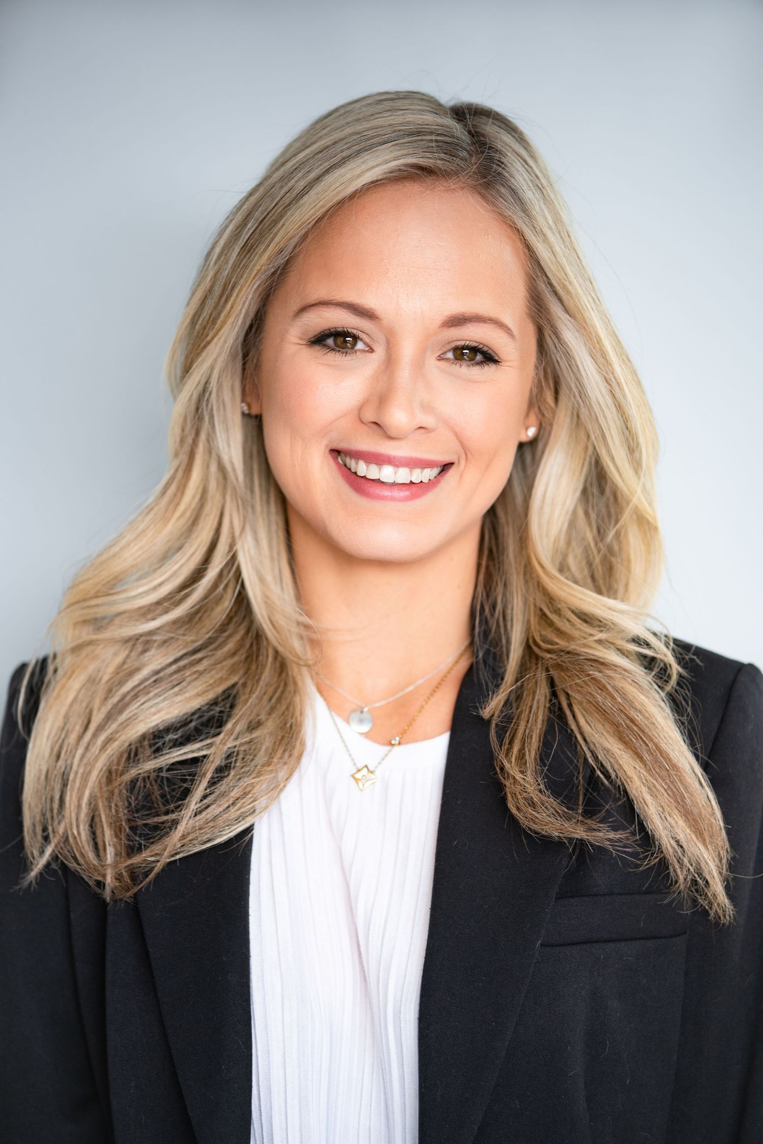 Professional headshots showing bright smile and blonde hair against light background.
