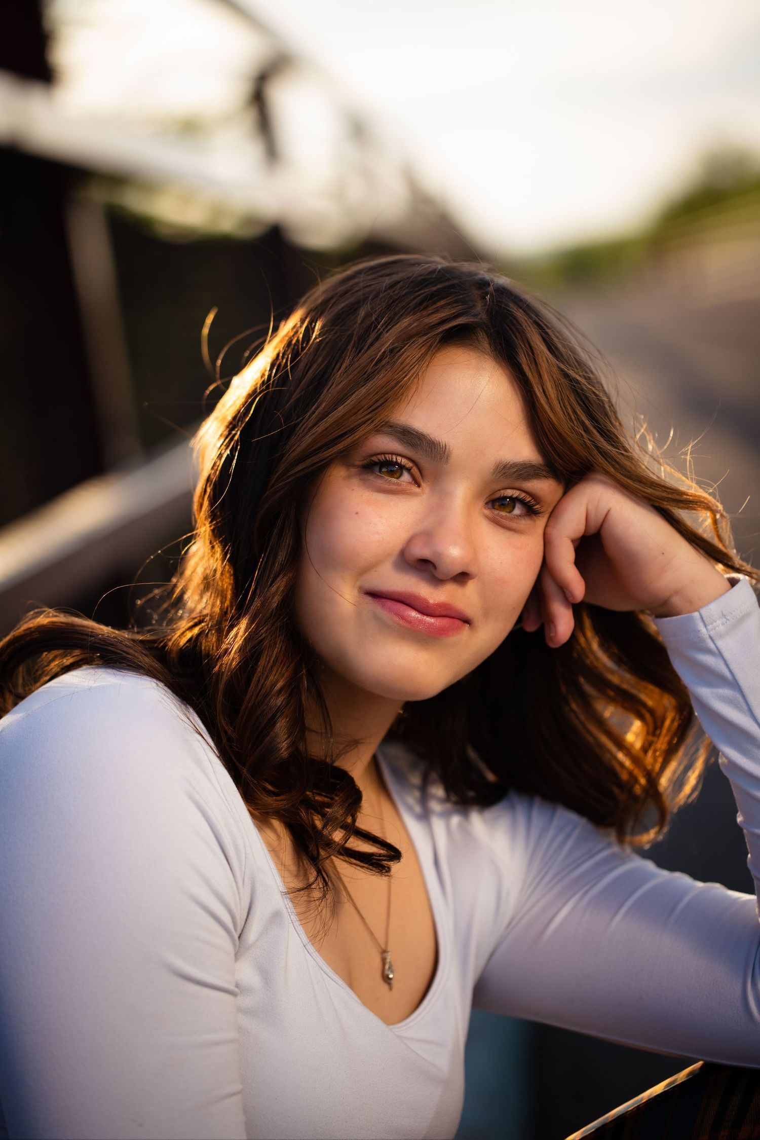 Artistic portrait series with dramatic lighting showing contemplative poses at golden hour.