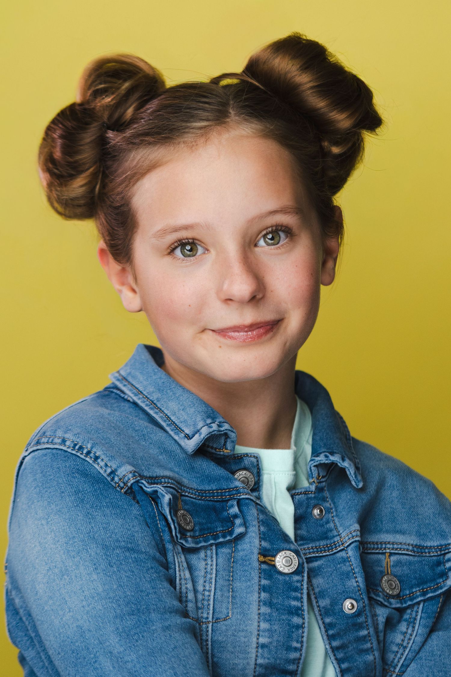 Portrait series in denim jacket against yellow background showing playful expressions.