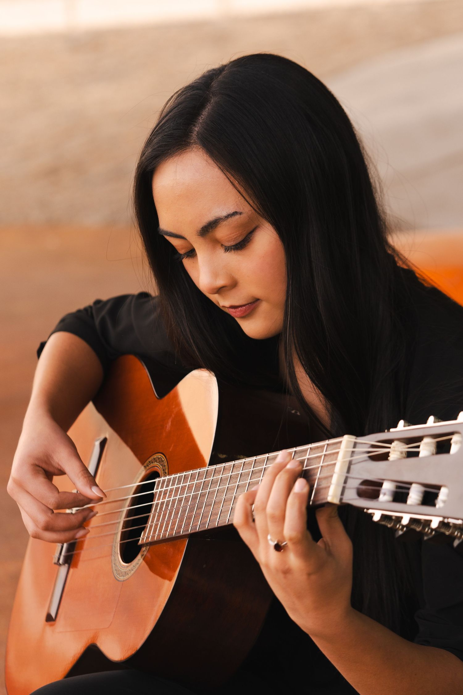 Close-up shots of hands playing classical guitar with warm lighting and artistic angles.