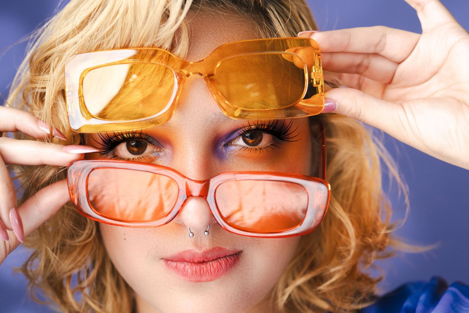 Close-up fashion shots with retro orange sunglasses and styled blonde hair.