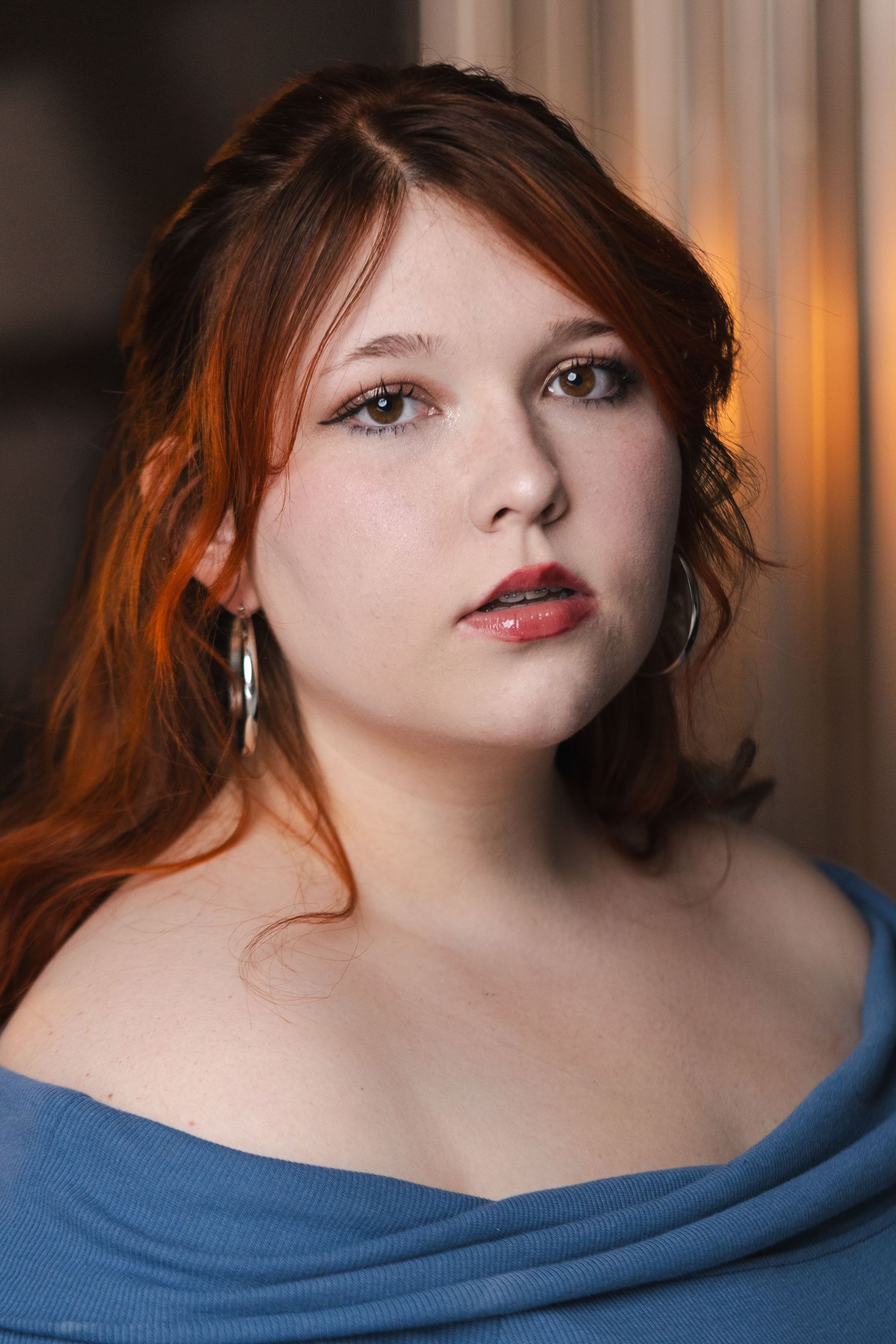 Dramatic portrait series in blue top with soft lighting and artistic composition.