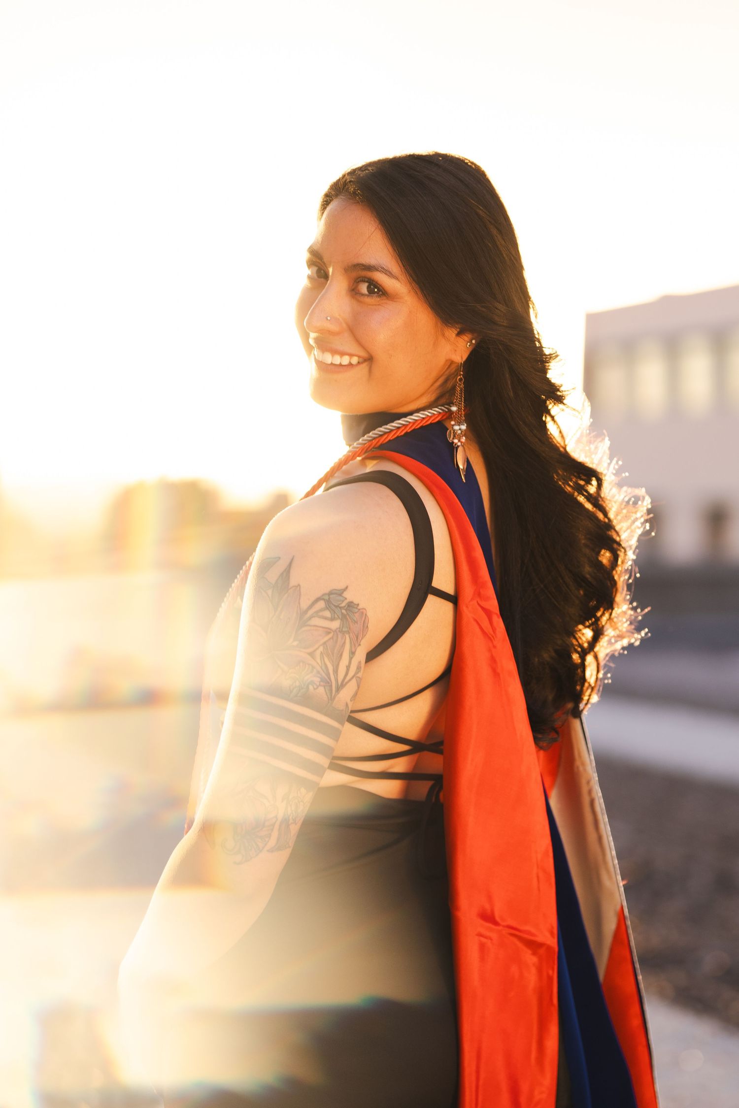 Graduation photos at sunset with academic regalia creating dramatic silhouettes.
