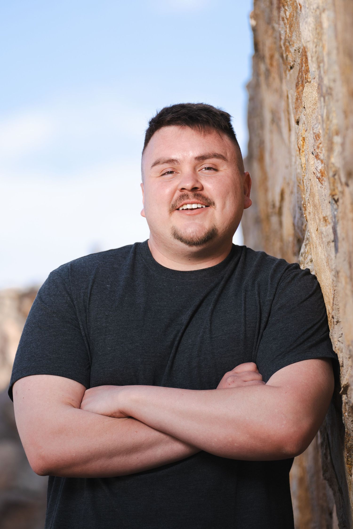 Casual portrait series against weathered concrete wall background.