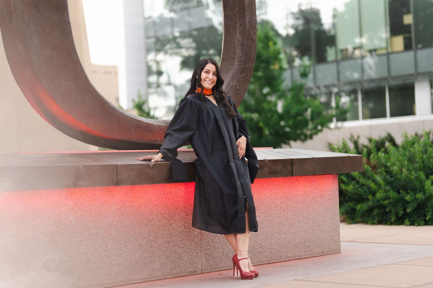 Urban photography session featuring red accents against modern architecture and landscaping.