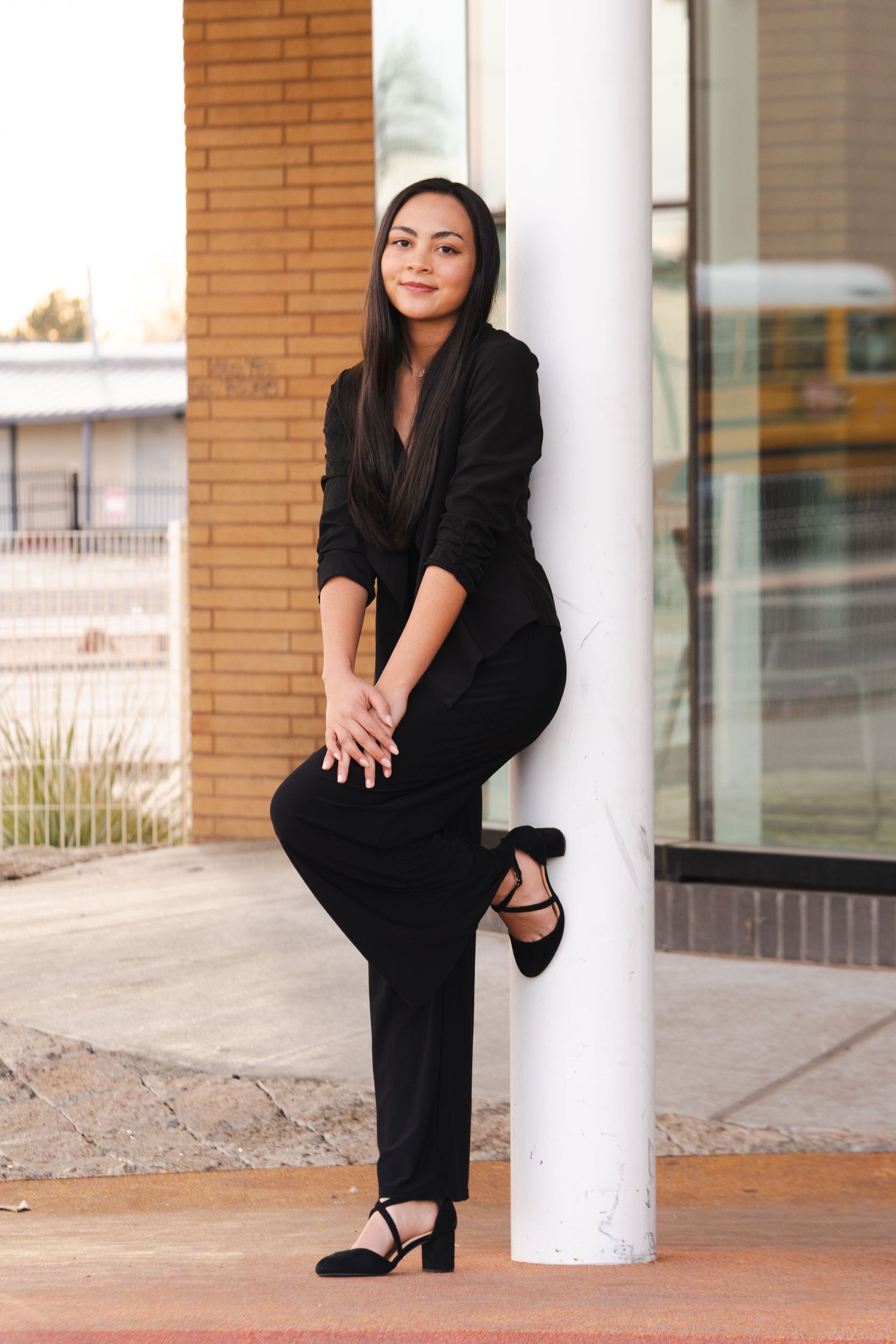 Professional portrait session with elegant black outfit against architectural columns.