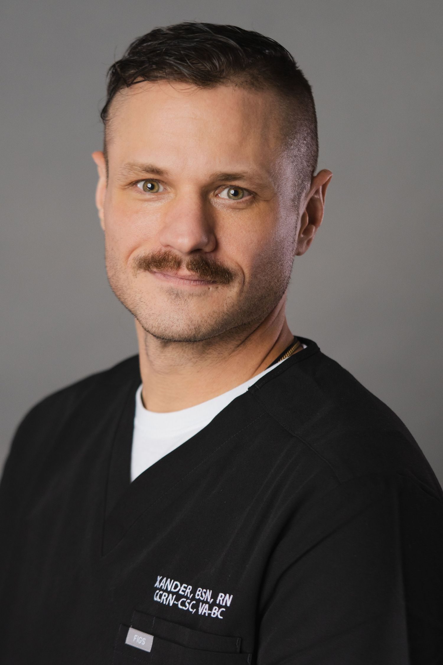 Professional headshots in black medical scrubs showing confident expression against grey background.