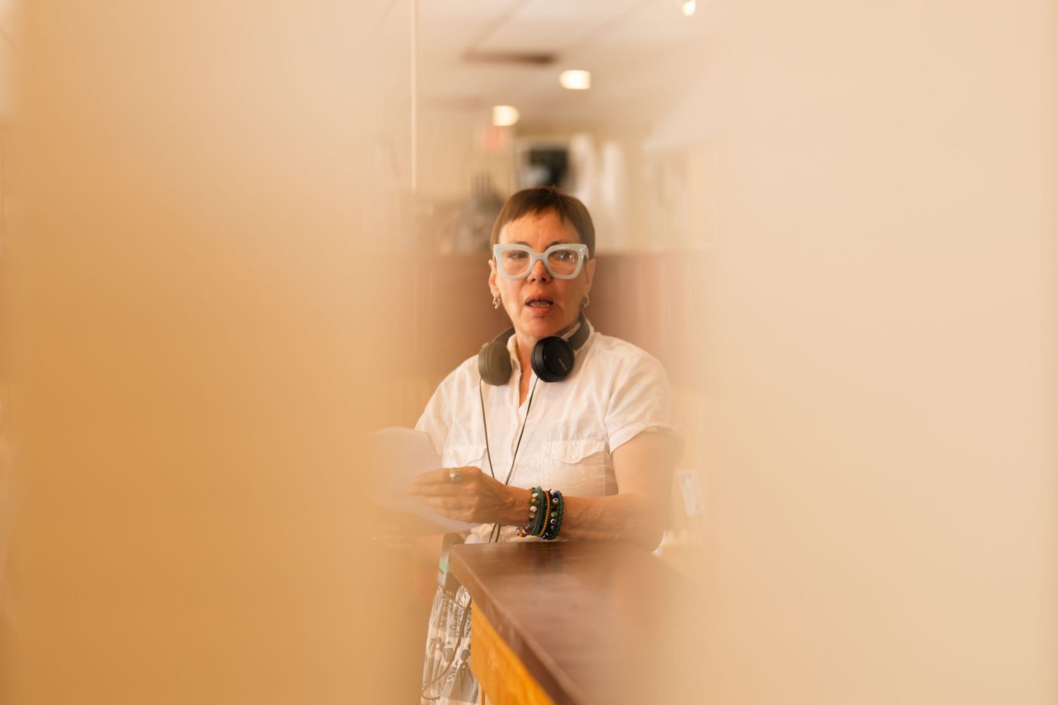Creative portrait through glass with soft focus and warm lighting.