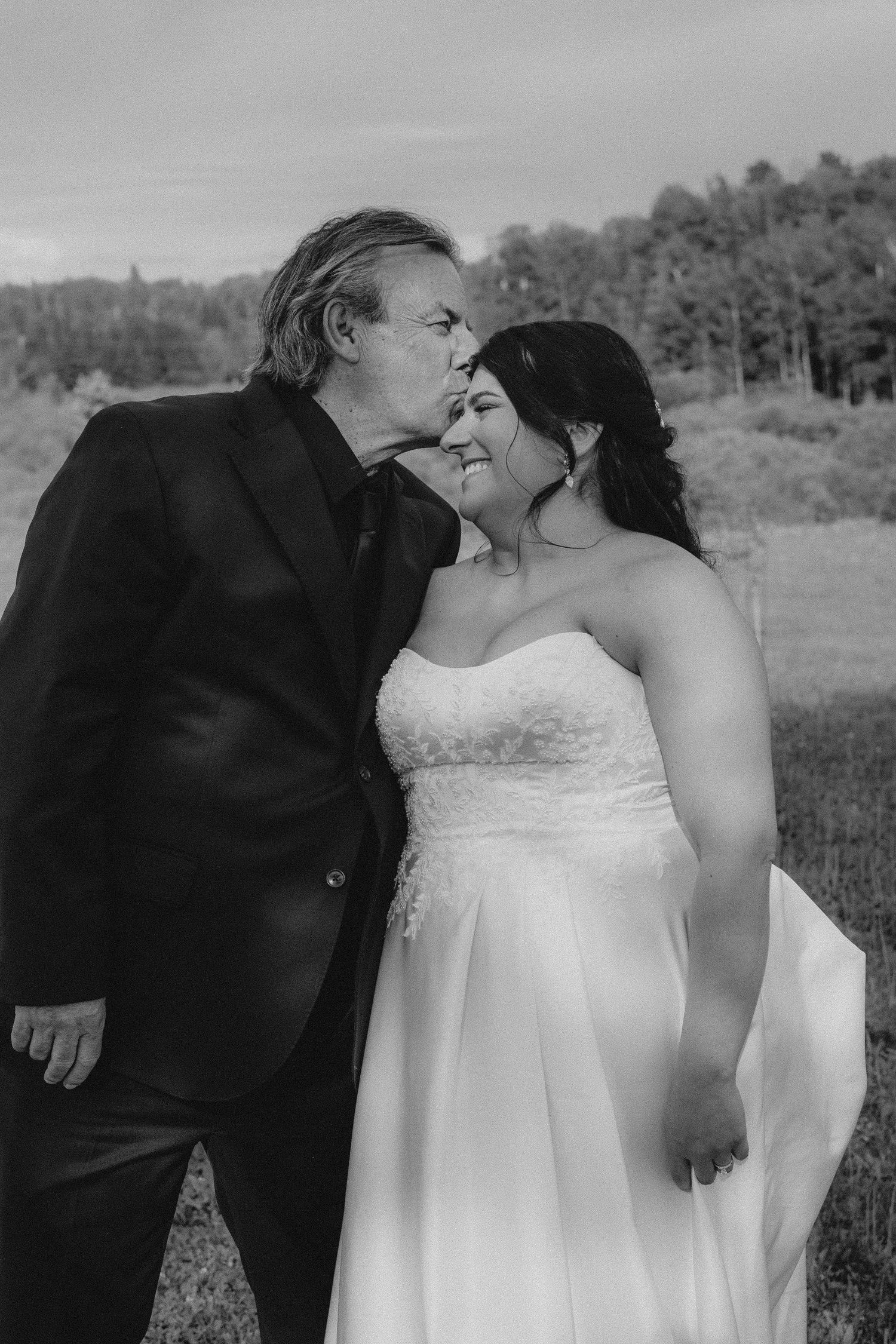 Romantic wedding sequence showing tender moments between newlyweds in an outdoor setting.