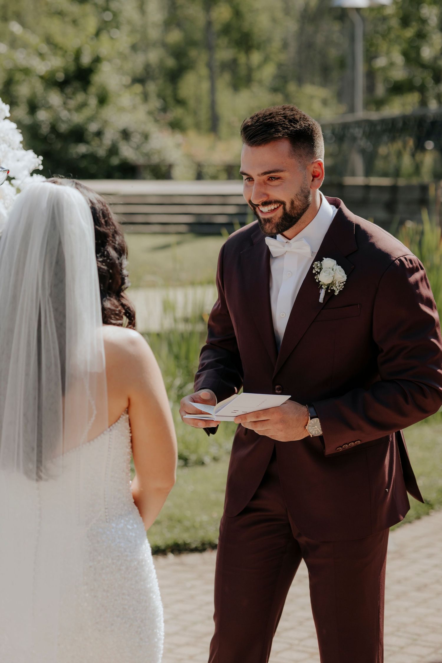Bride and groom sharing intimate moments in an outdoor garden setting.