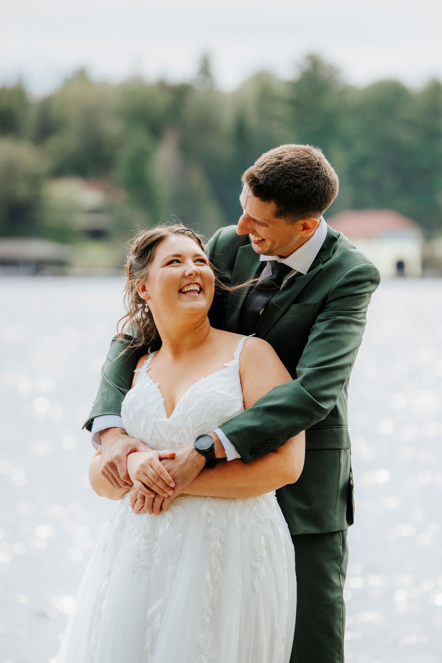 Romantic waterfront wedding photos showing tender moments between newlyweds.