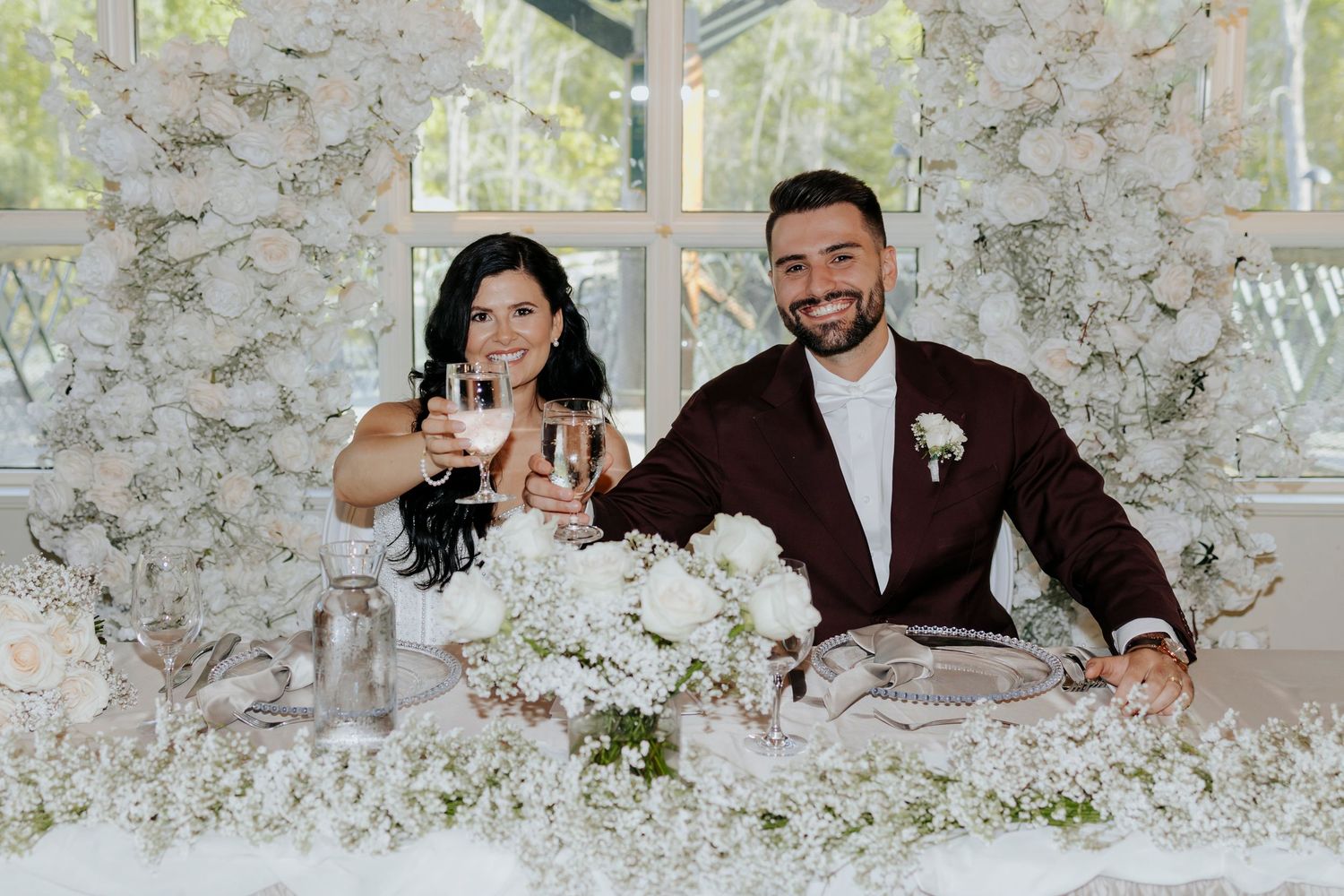 Wedding couple sharing intimate moments at reception with floral decor.