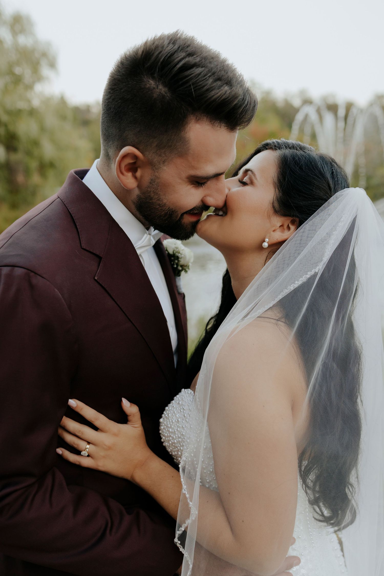 A series of romantic wedding photos showing a couple sharing intimate kisses outdoors during their ceremony.