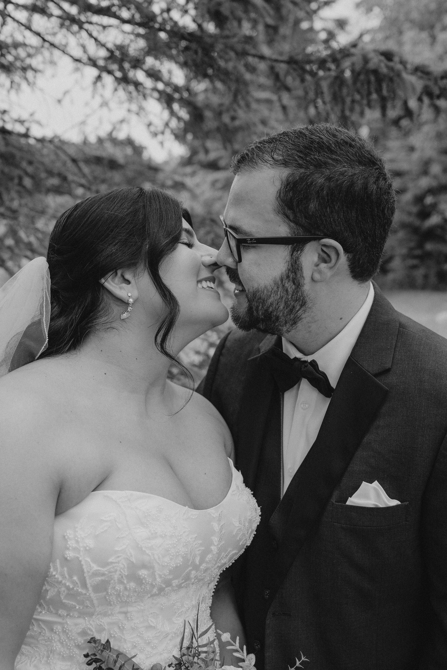 A romantic black and white photo sequence showing a couple sharing tender kisses during their wedding day.