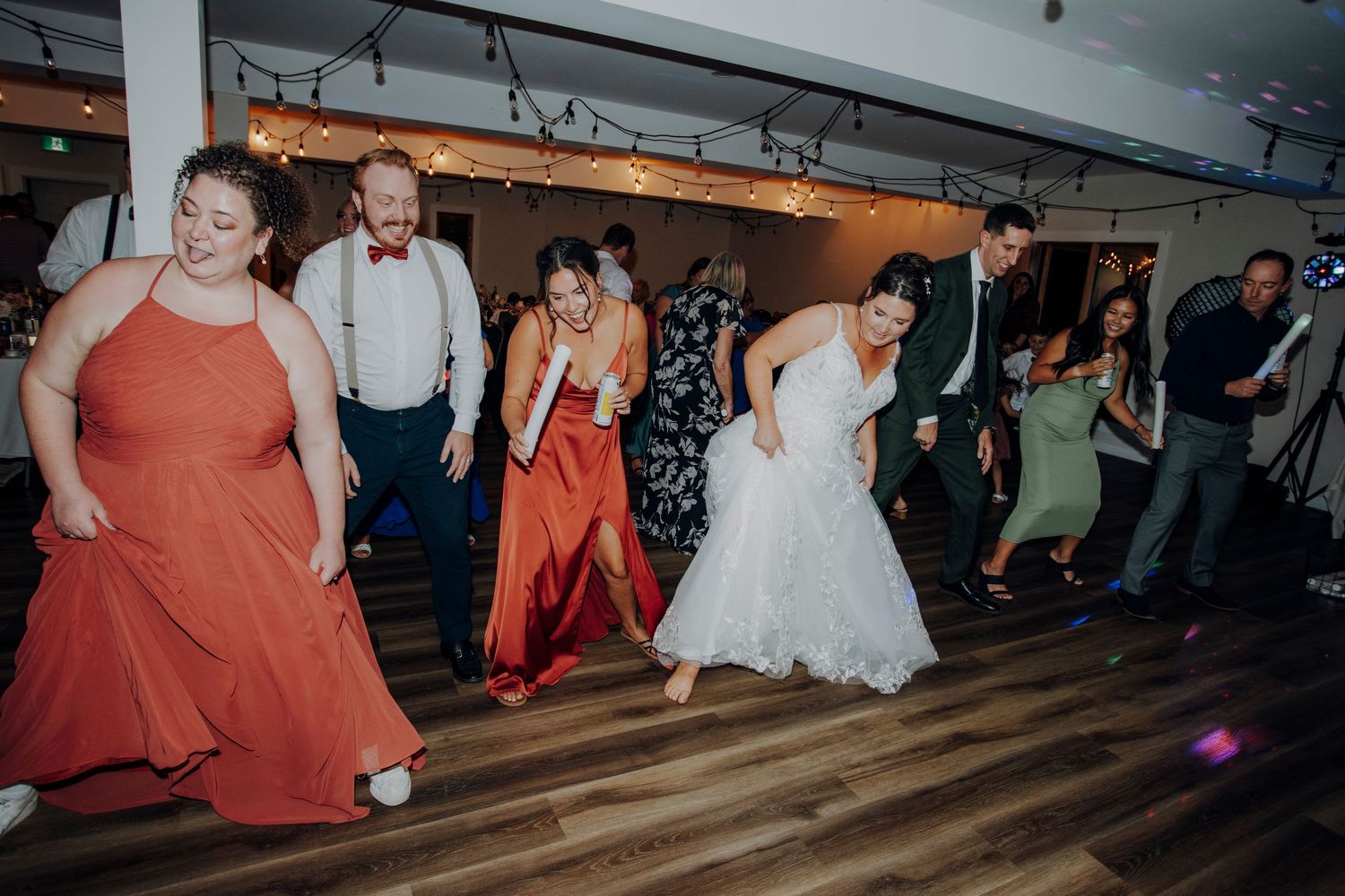 Wedding reception dance floor filled with guests celebrating.
