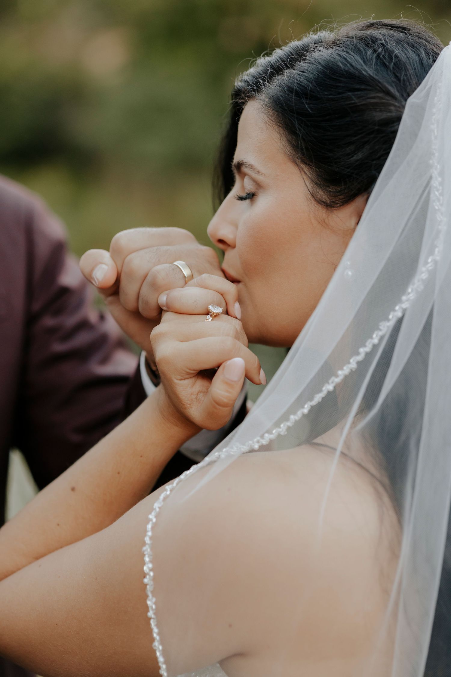 Emotional moment captured through veil during wedding ceremony.