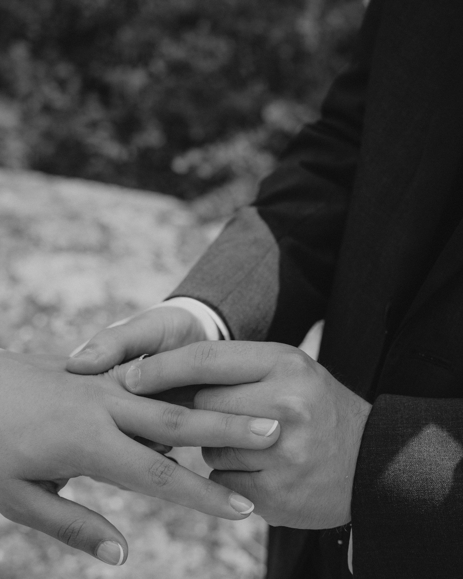 A series of black and white photographs showing two hands clasped together in different intimate poses.