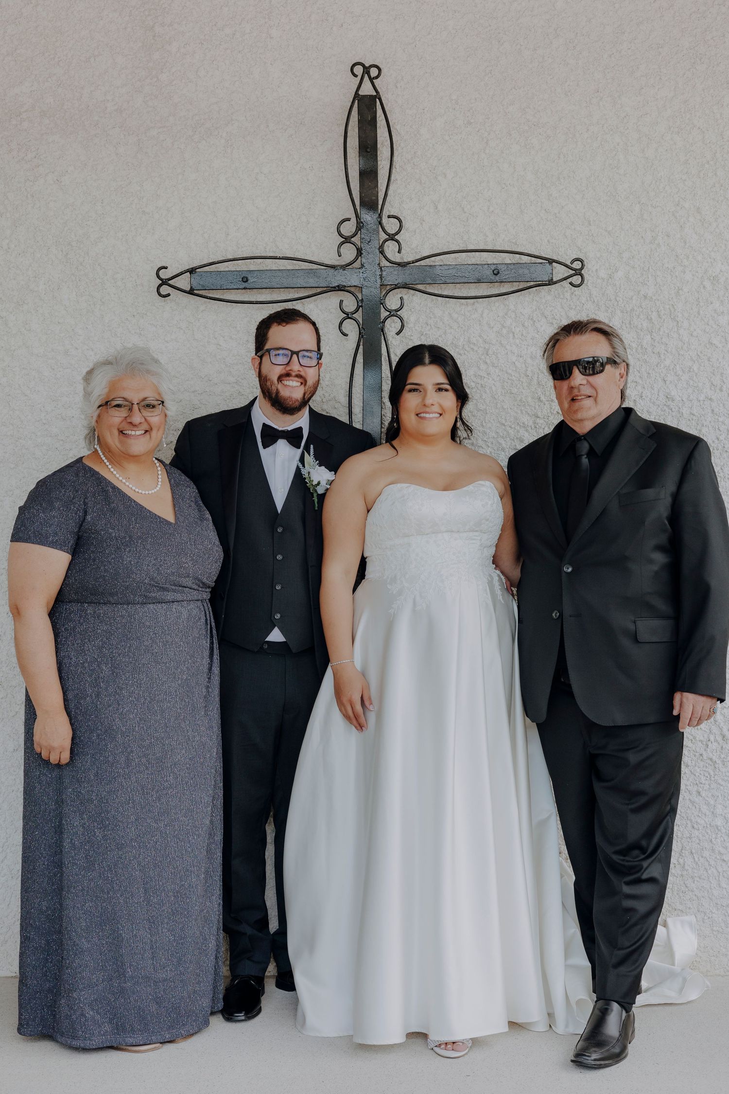 A creative sequence of wedding party photos showing four people in formal attire against a gray wall.