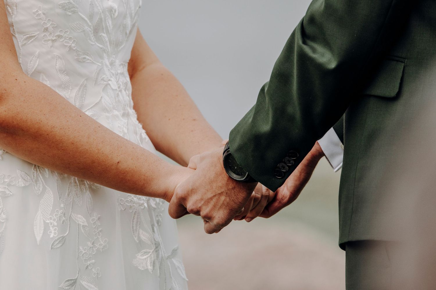 Close-up shot of hands holding during a wedding ceremony.