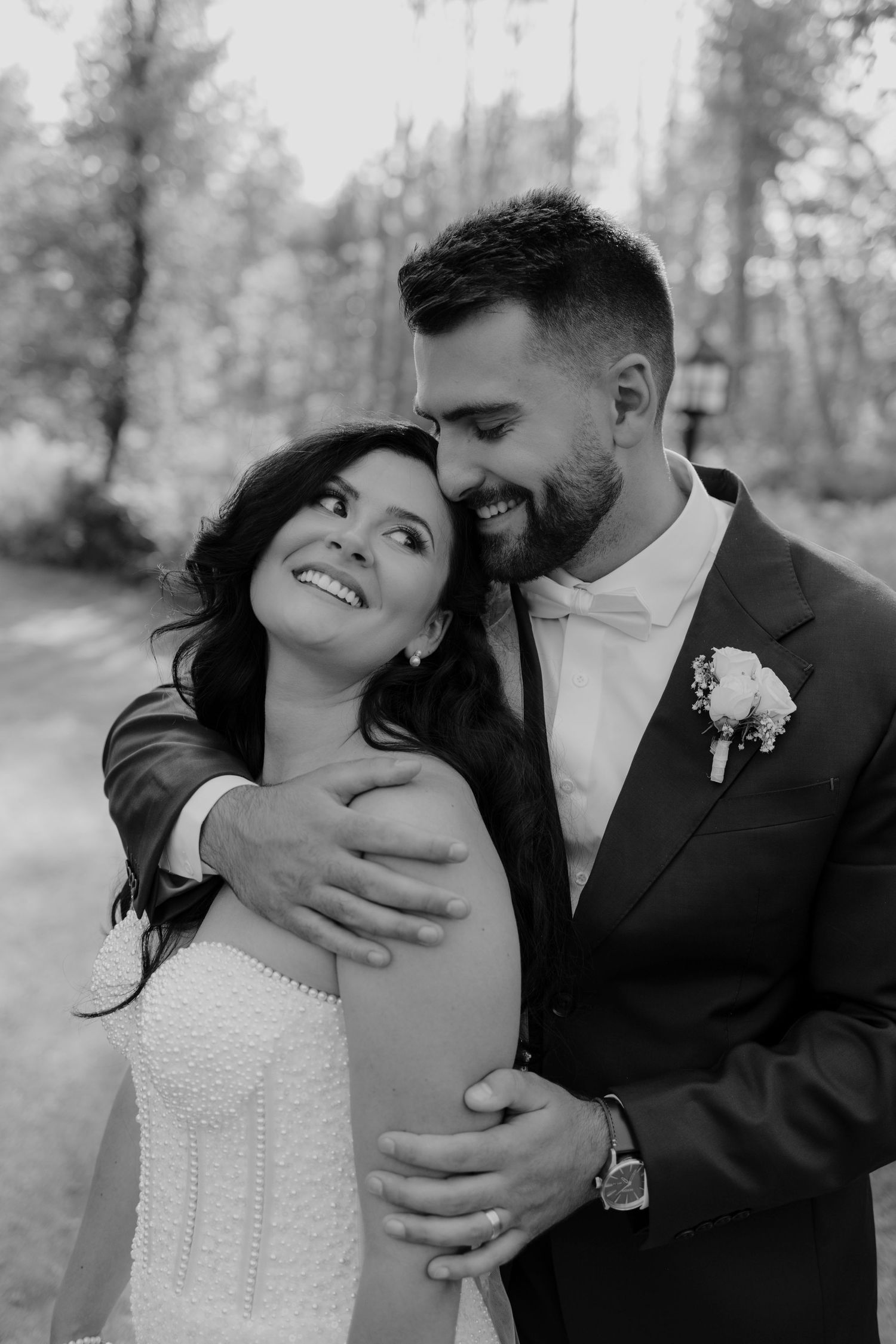 A romantic black and white photo series showing a couple in wedding attire sharing intimate moments outdoors.