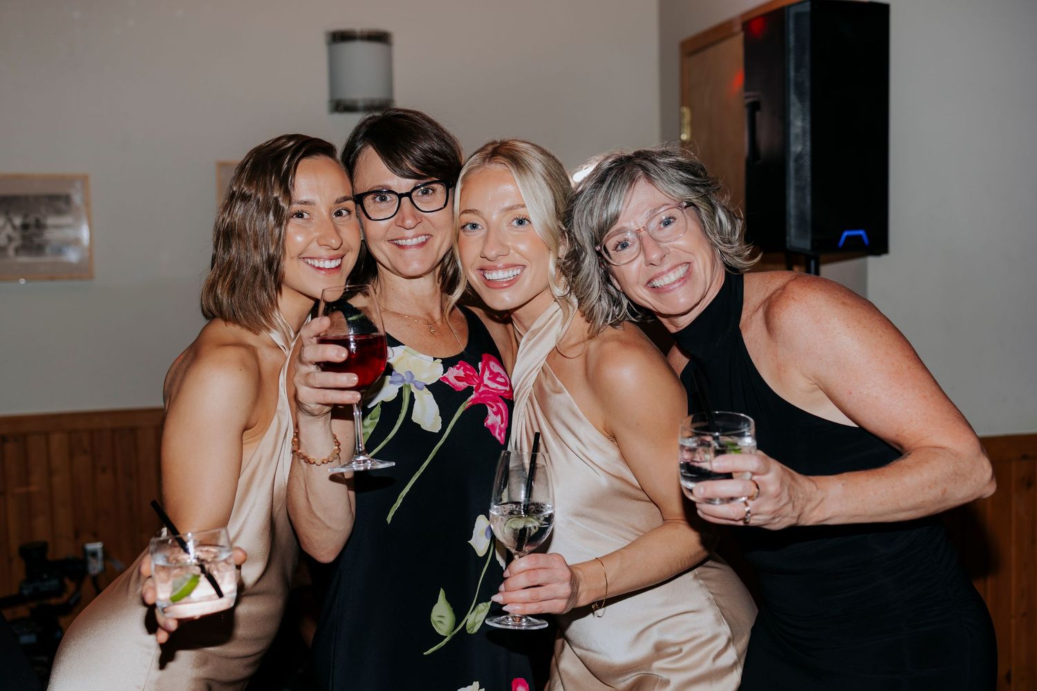 Wedding reception celebration with guests enjoying drinks and laughter.