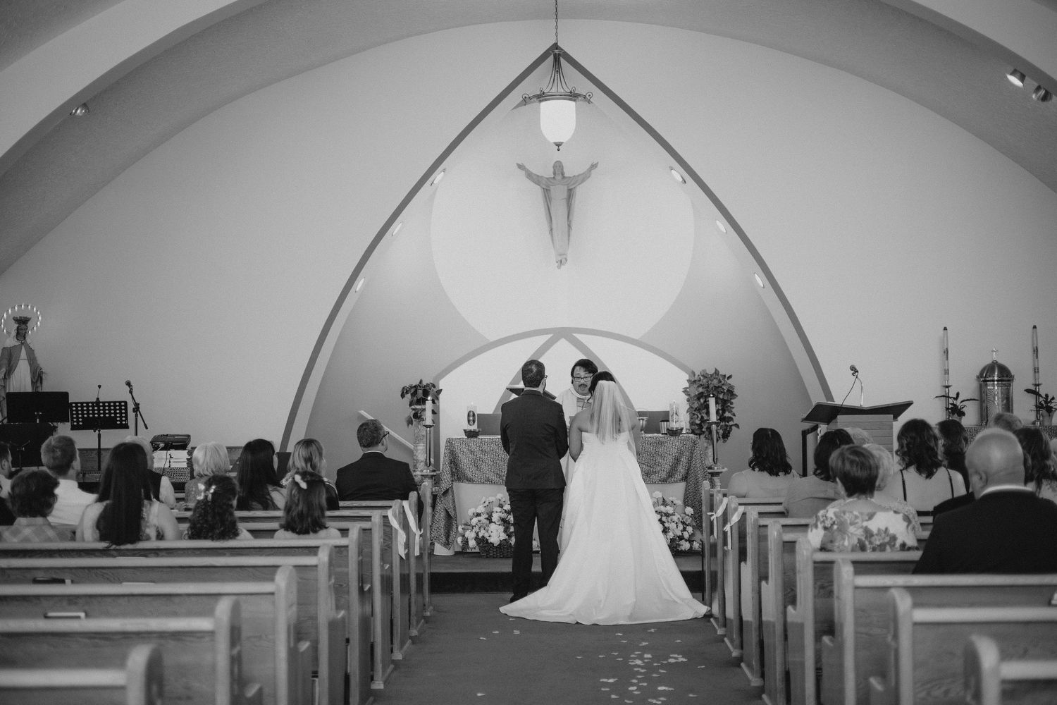 Interior view of a church sanctuary set up for a wedding ceremony with arched ceiling.