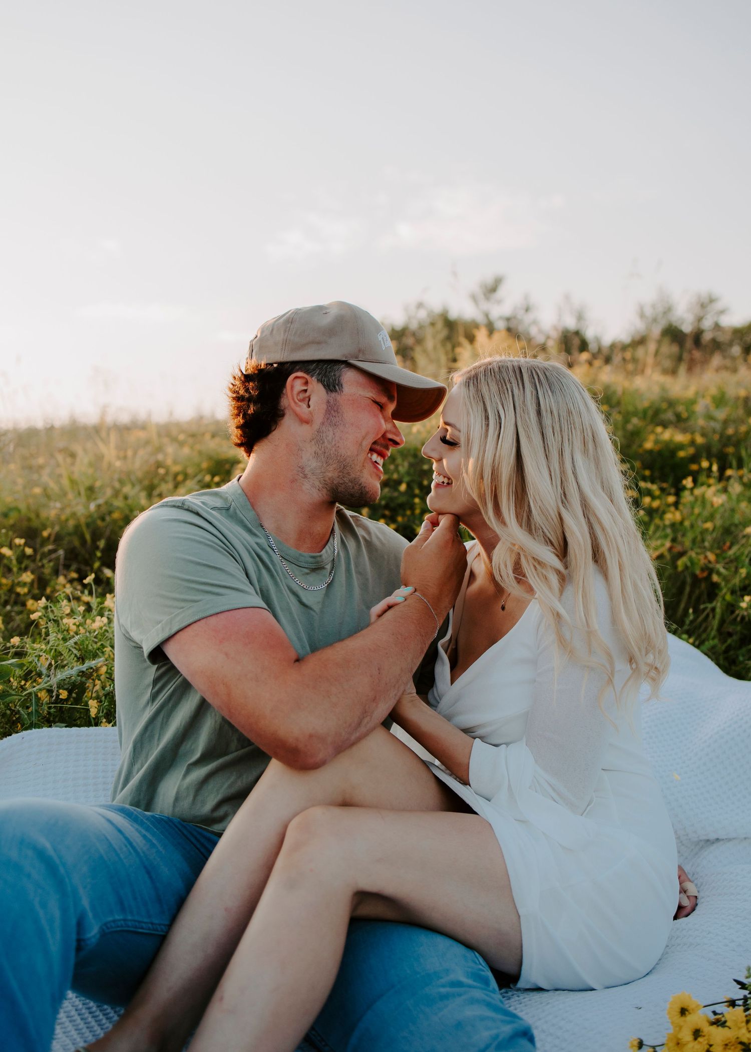A romantic sunset photoshoot in a wildflower meadow with soft natural lighting.