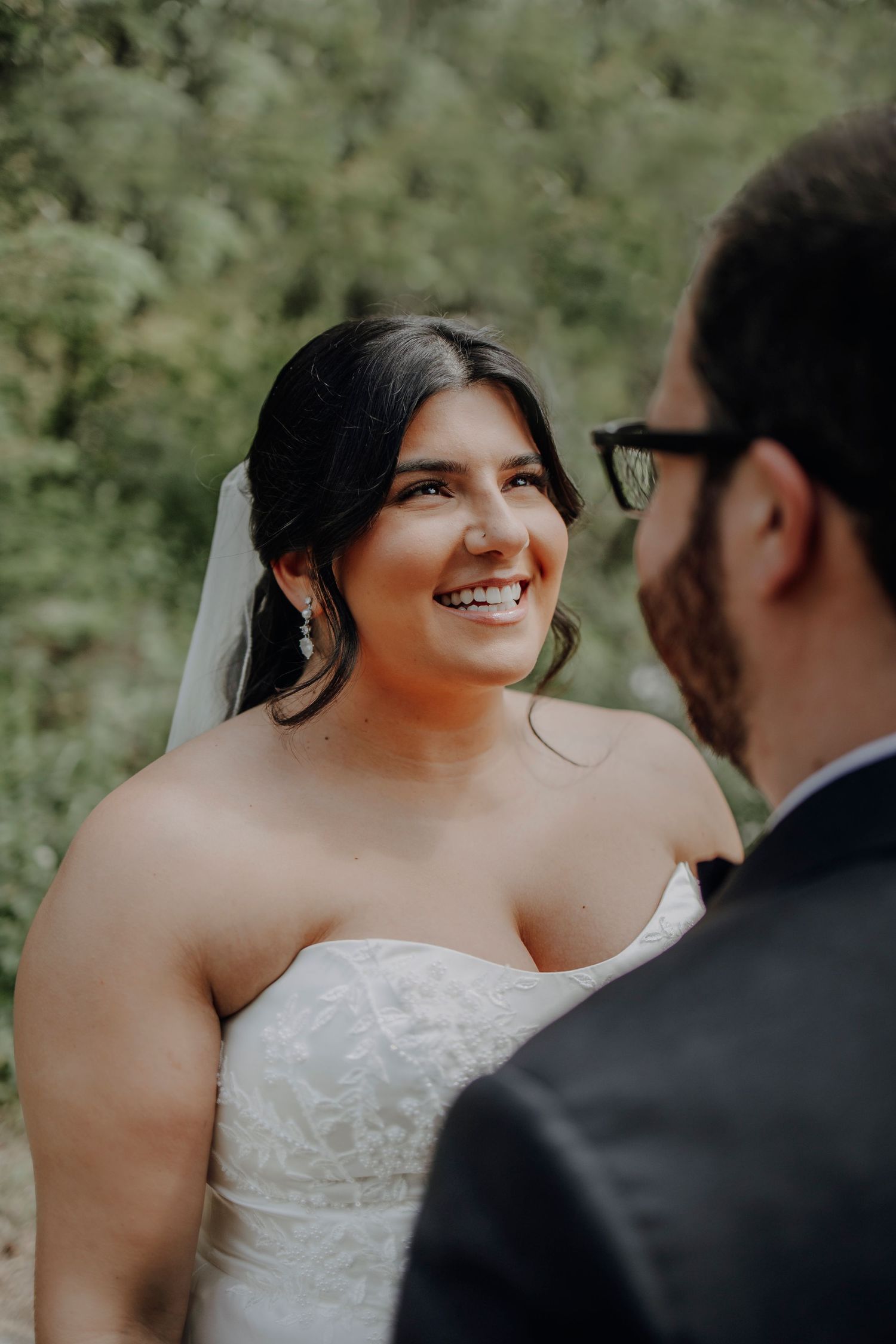 A couple shares an intimate moment in a romantic outdoor wedding setting.