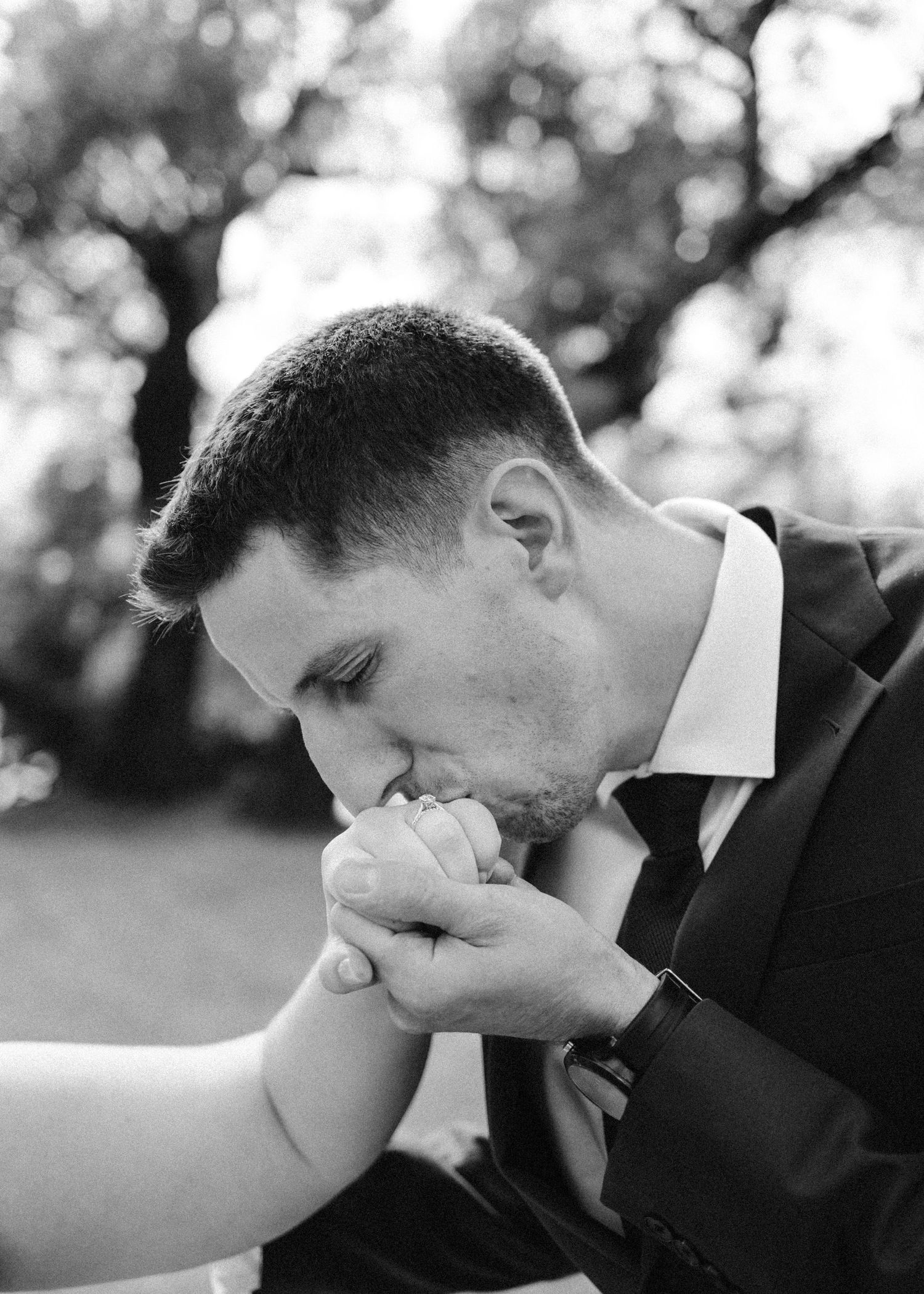 A sequence of romantic wedding kisses between the couple in black and white.
