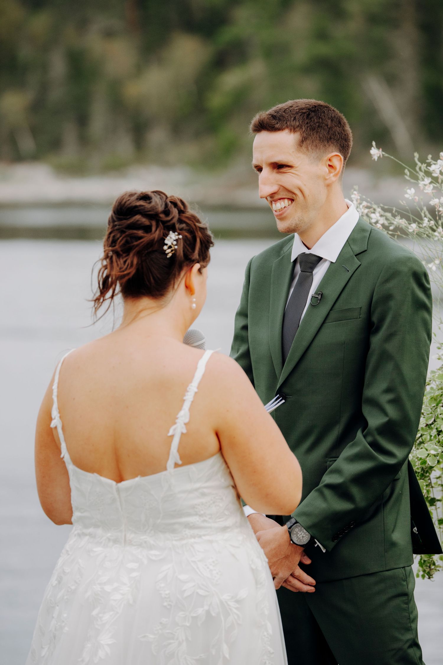 Close-up sequence of a couple in wedding attire, with the bride in white and groom in dark green suit.