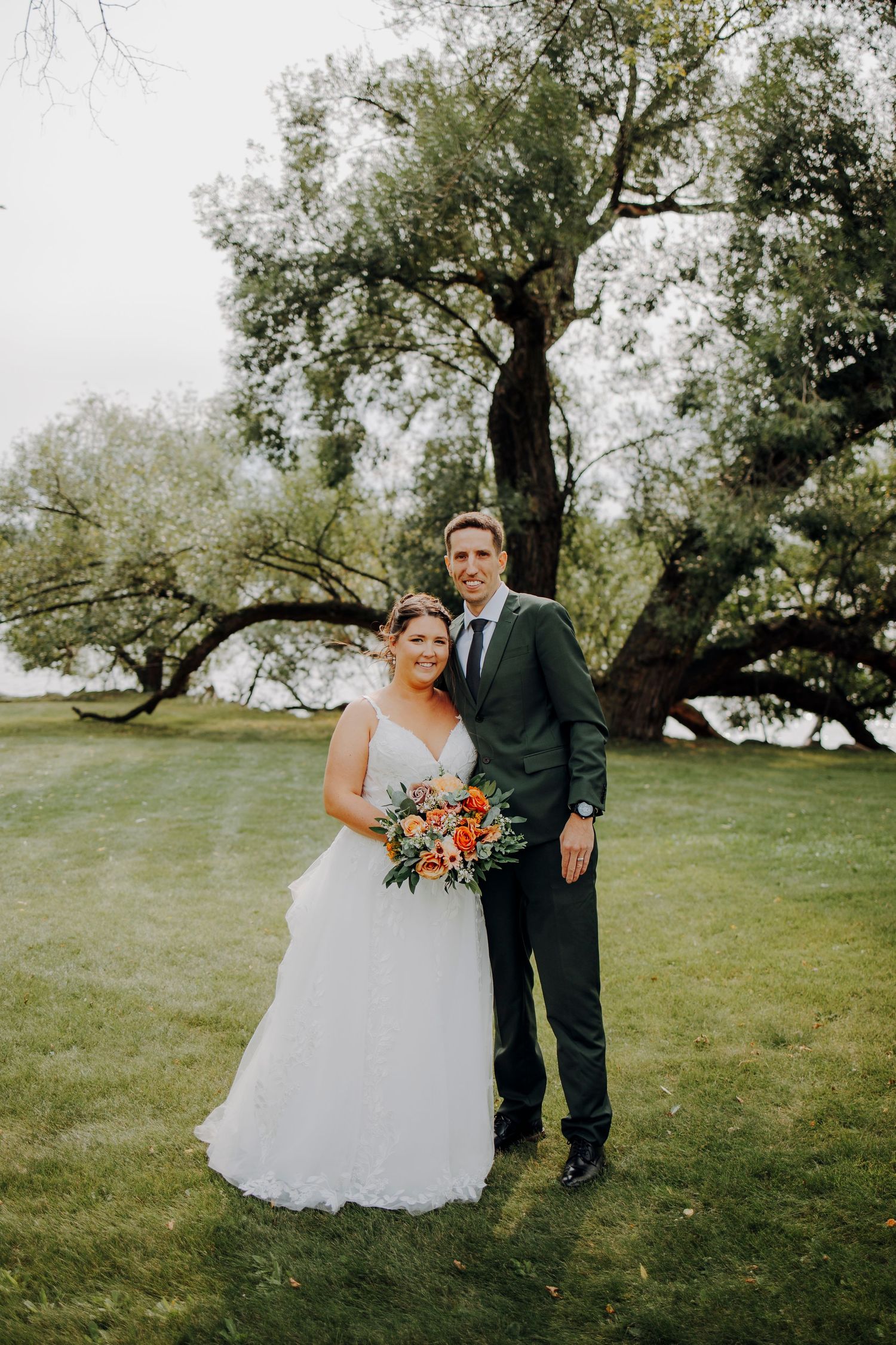 Wedding portraits captured in natural outdoor setting with trees and greenery.