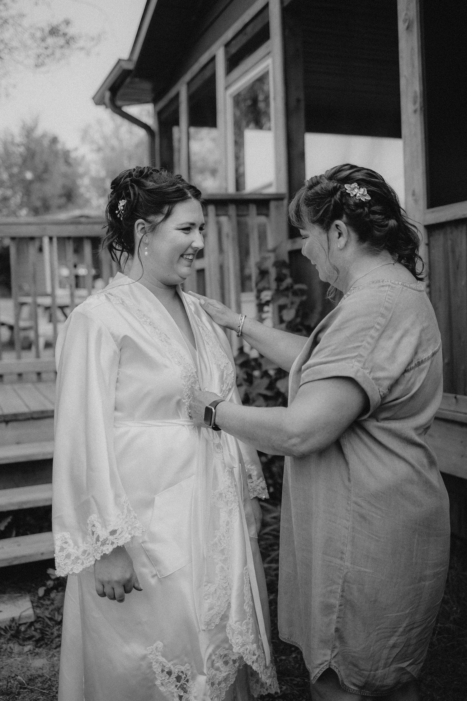 Getting ready moment as two people share a joyful interaction before the ceremony.