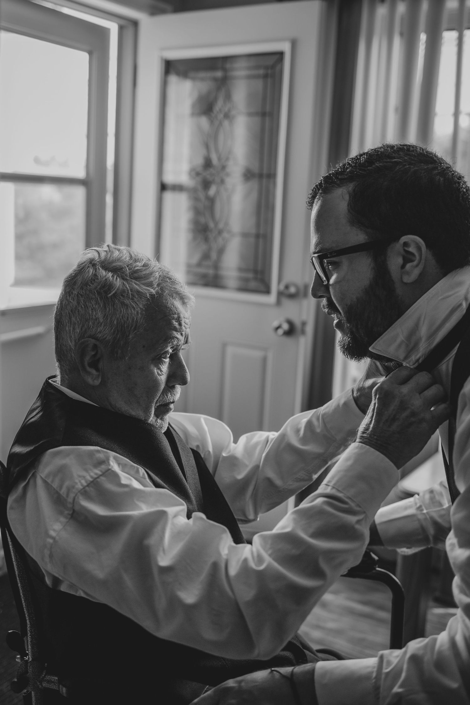 A touching black and white moment captured during a wedding celebration.