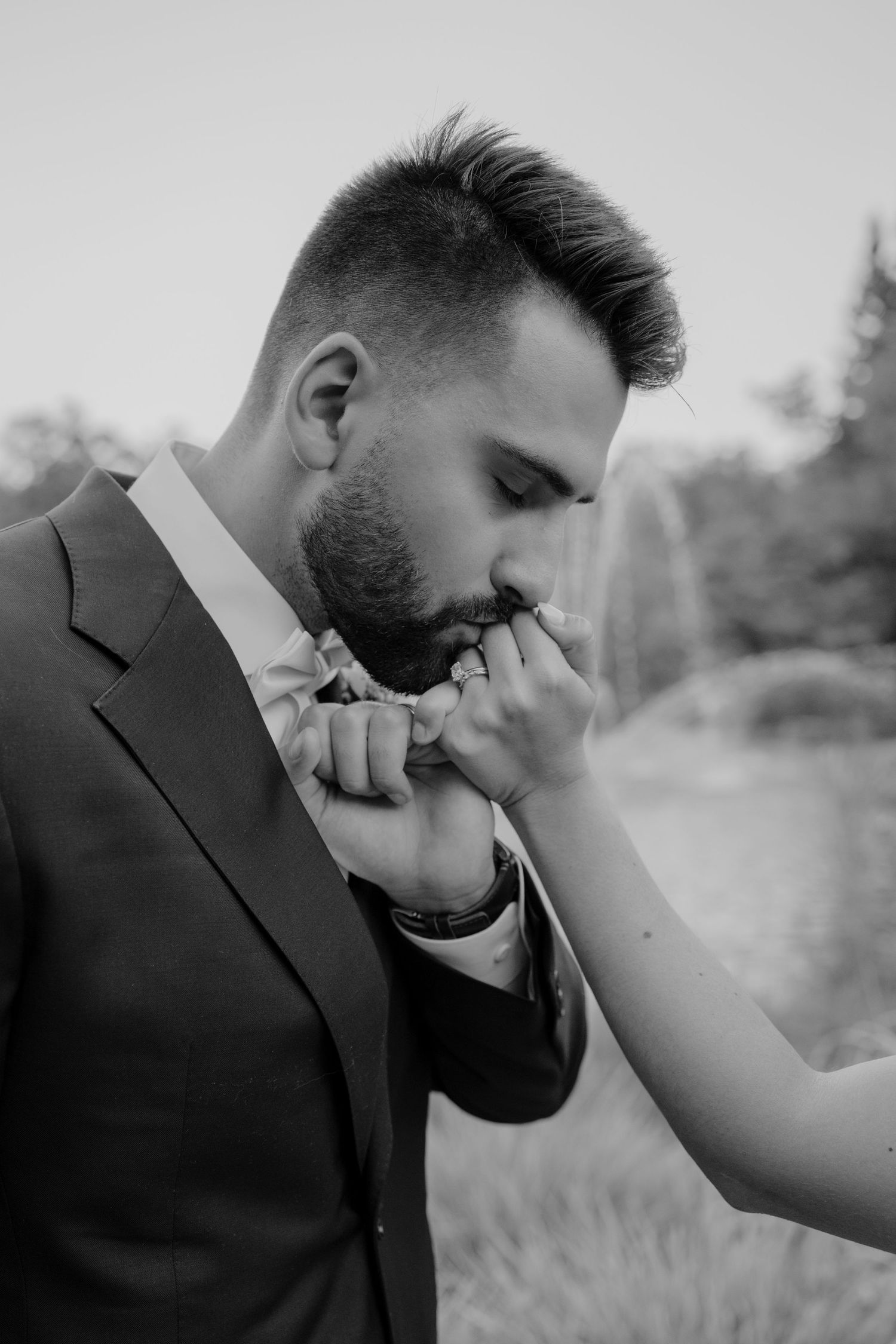 An intimate black and white moment captured during a wedding photoshoot.